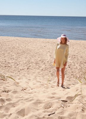 Очаровательная девка в шляпке оголяет попу на пляже